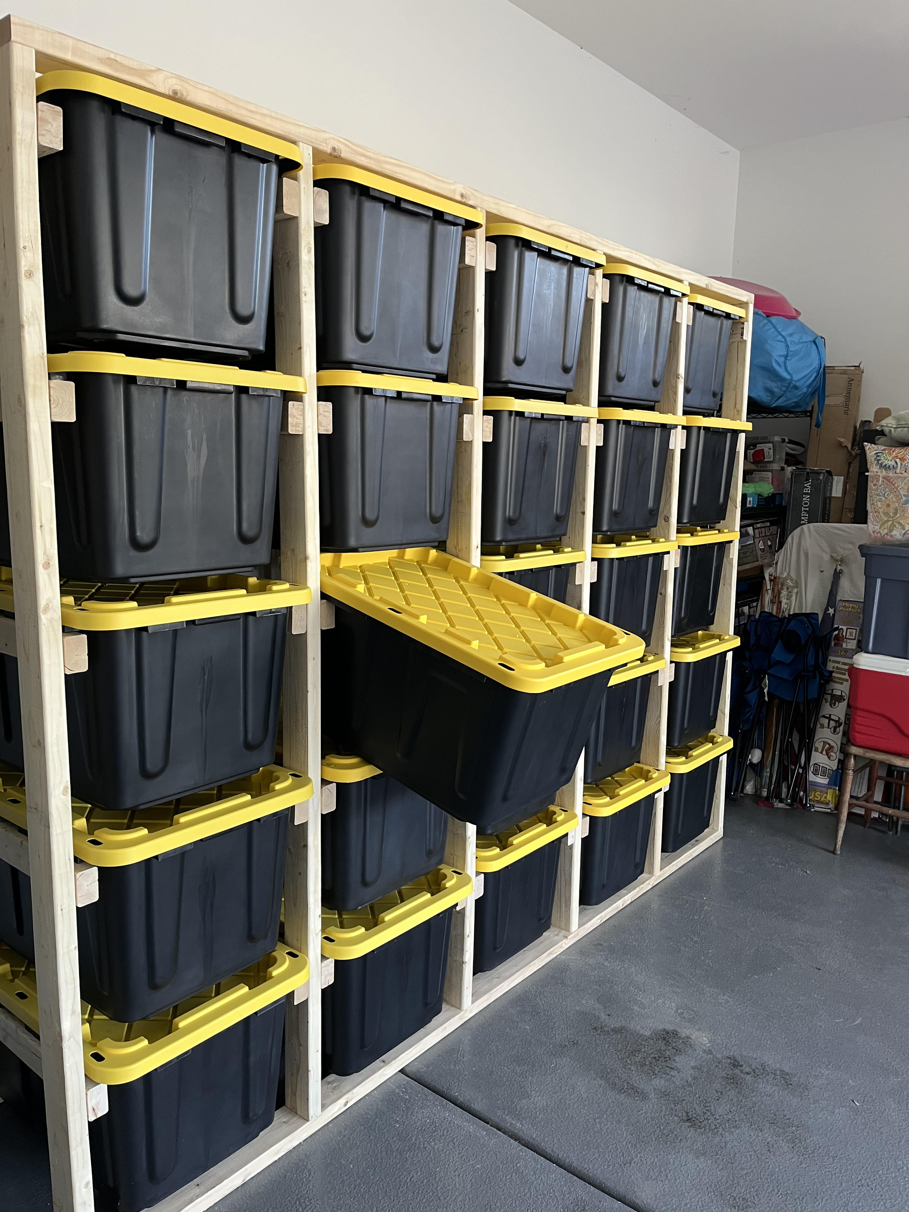 Storage system installed in garage with slide-out totes